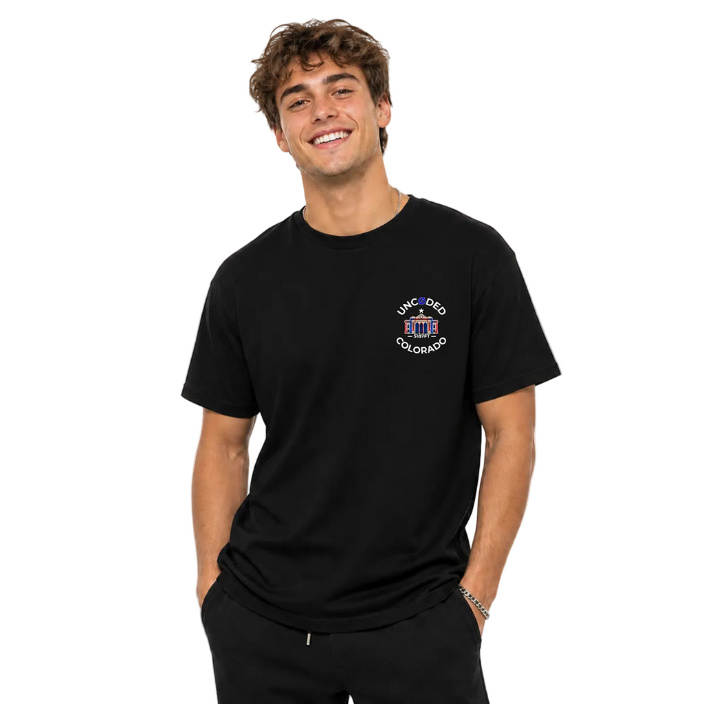 Model wearing UNCØDED 5187 Station Tee black Colorado graphic tee front view