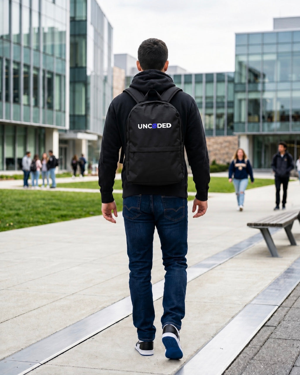 Person wearing UNCØDED Backpack black streetwear laptop bag with blue Ø logo #group:blue